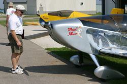 A Fly-In attendee inspects Kerry Fores' "Metal Illness".