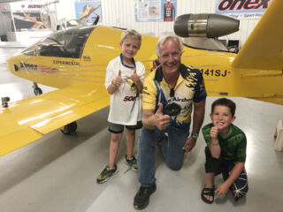 Bob Carlton poses with a couple of his fans after his Fire & Lights Night Pyro Airshow.