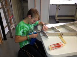 Adam riveting the tail at 12 years old.